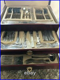 SBS Stainless Steel & Gold Plate, 86 Piece Cutlery Set. Red faux wood chest